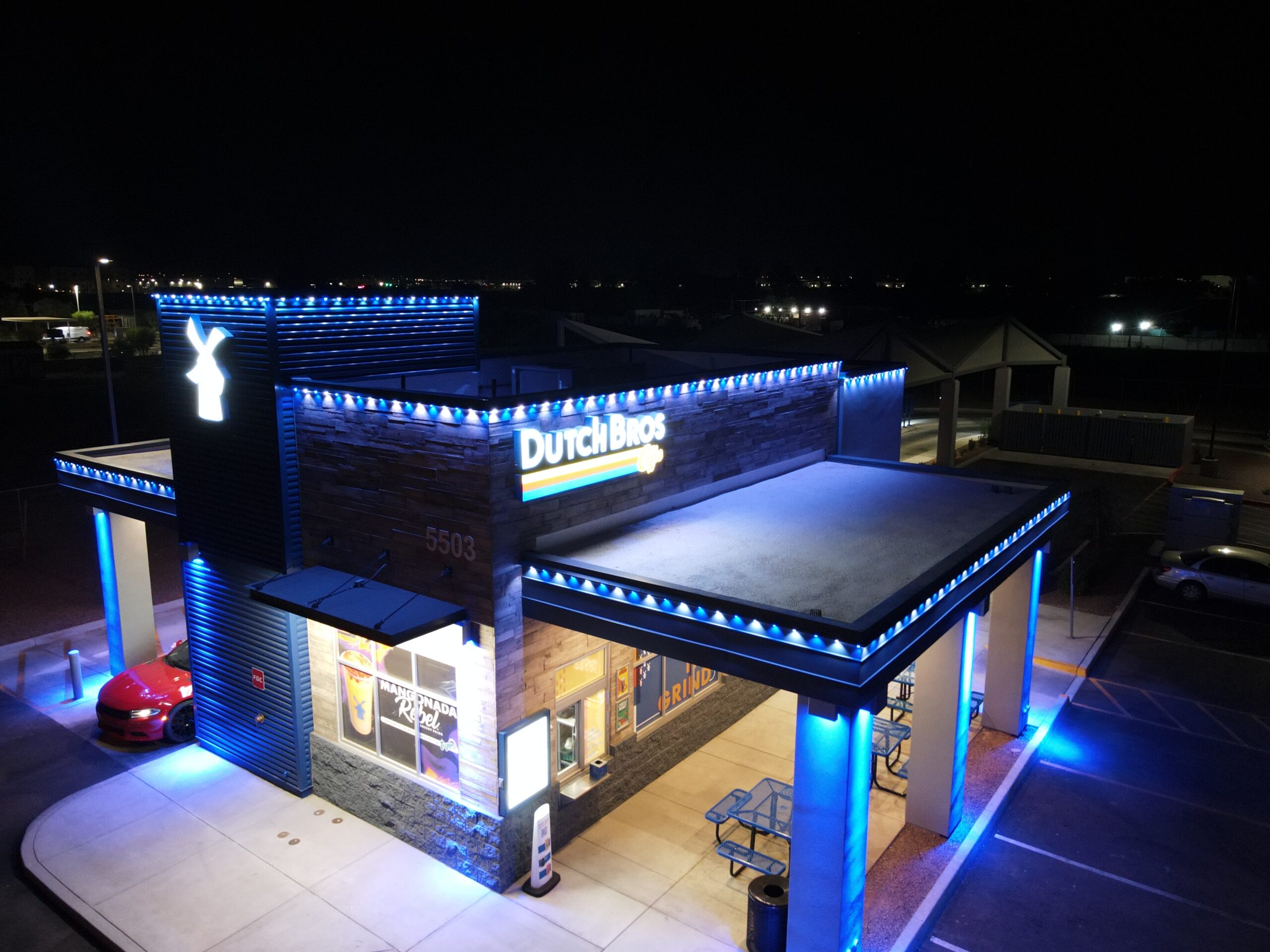 Dutch Bros Coffee building outlined in blue commercial accent lighting at night