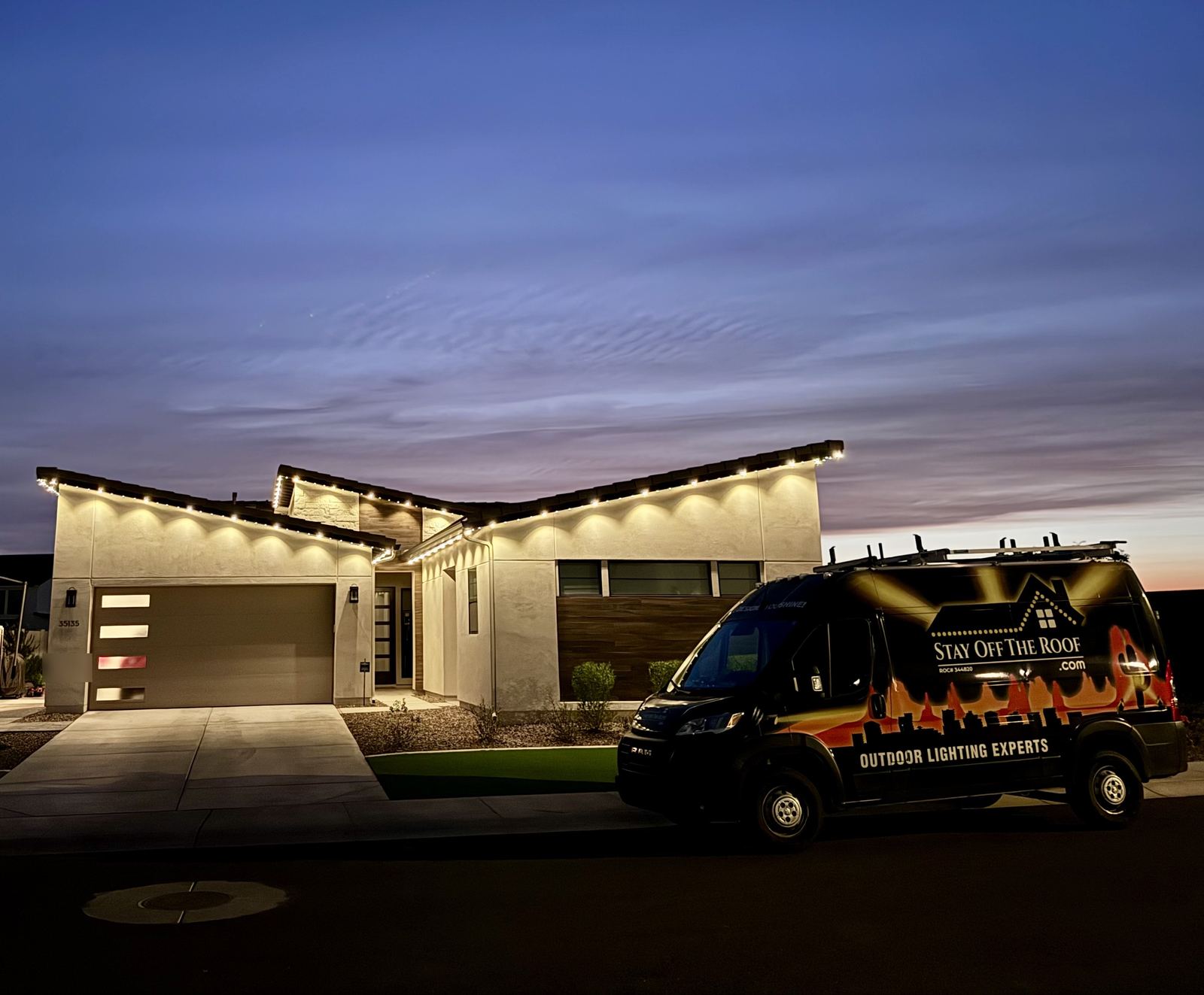 Gemstone permanent trim lighting in warm white installed by Stay Off The Roof on a modern Scottsdale, AZ home, with the Stay Off The Roof outdoor lighting van in front