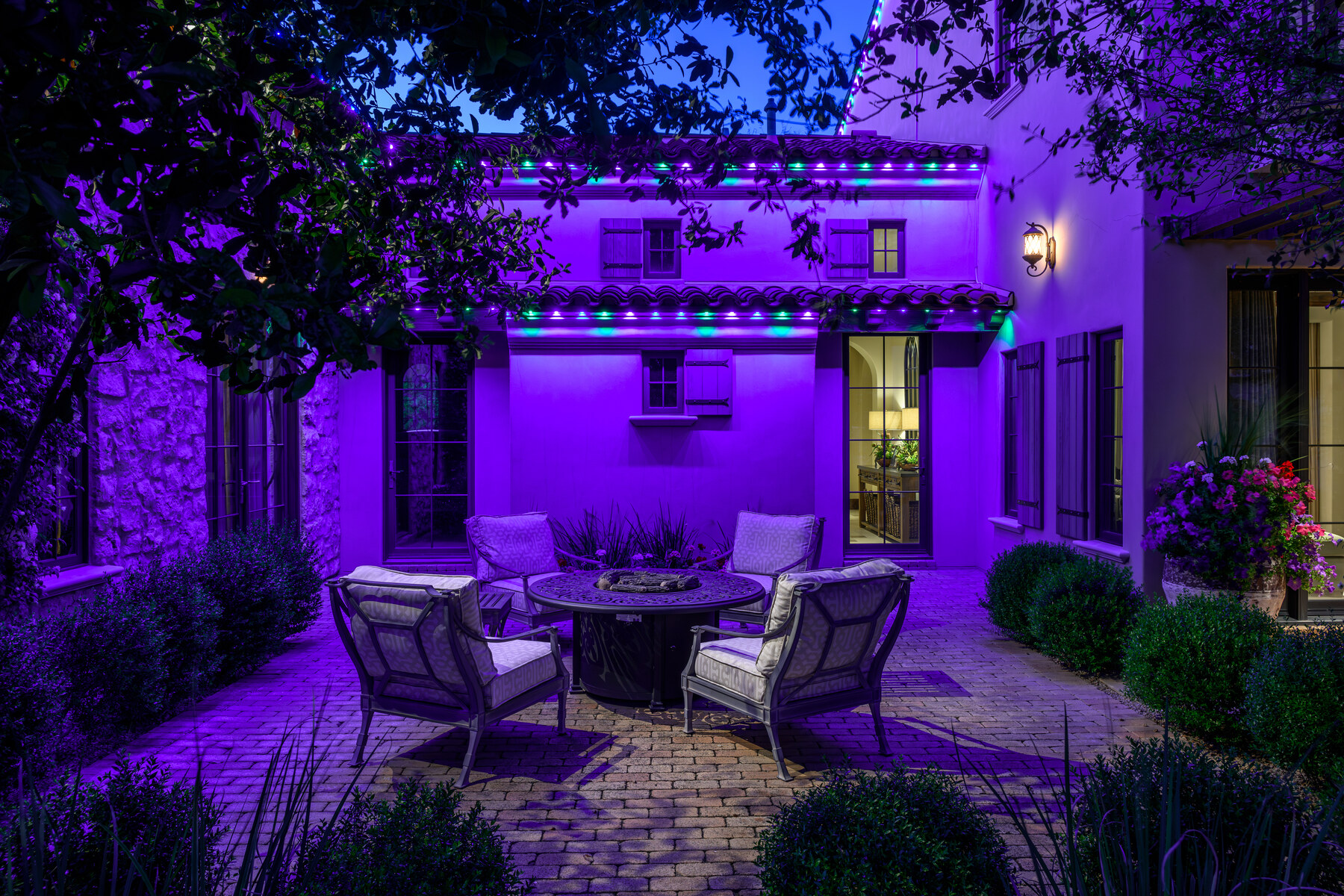 Purple permanent roofline lighting on a Chandler, AZ estate at night