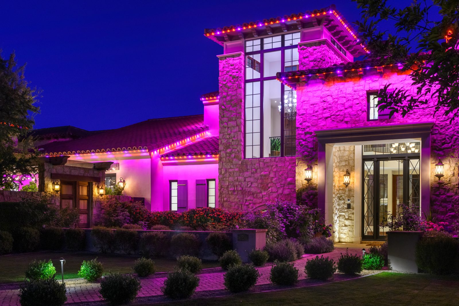 Magenta game-day color on a permanent roofline lighting system, East Valley estate