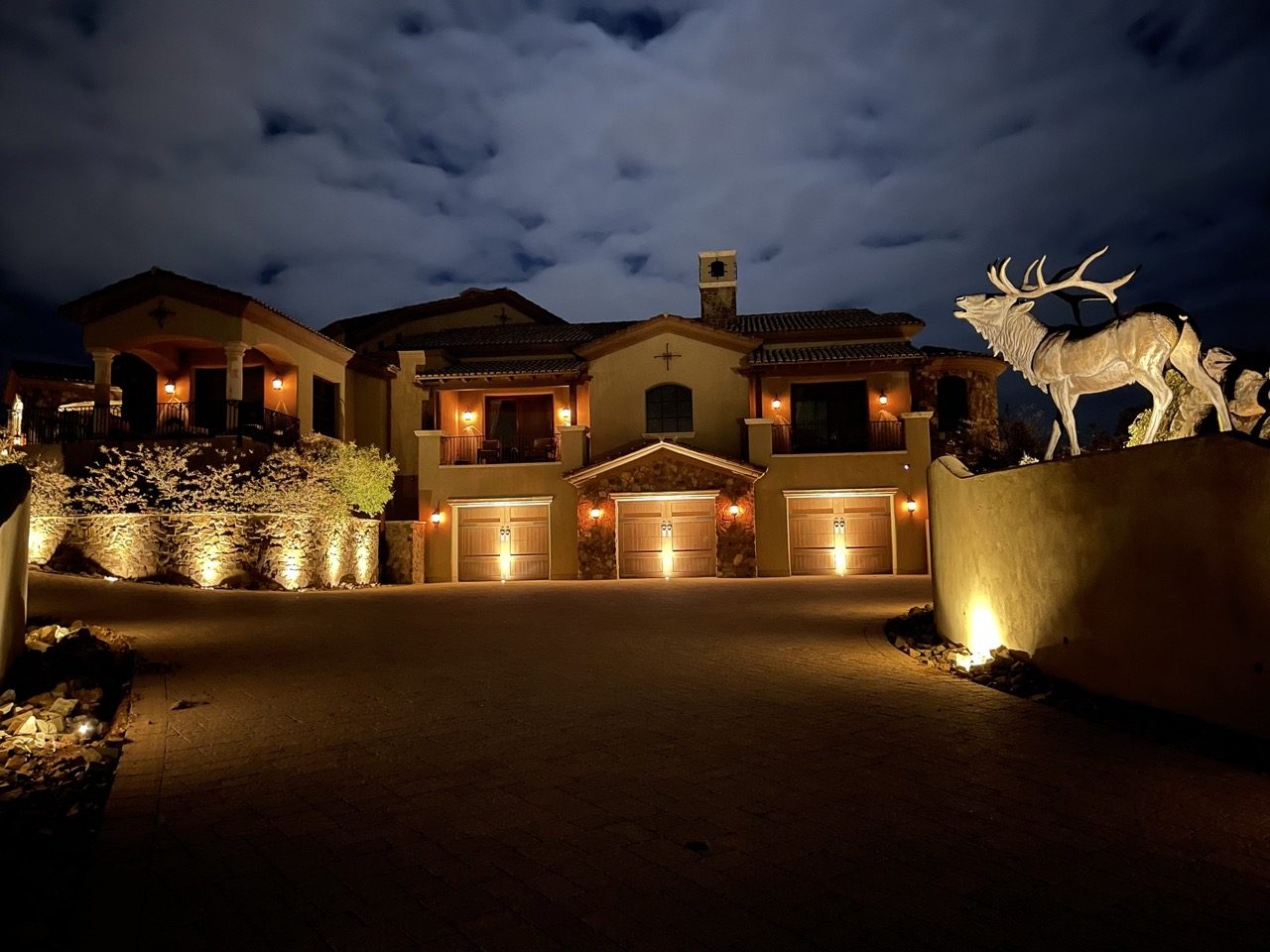 Warm landscape and facade lighting on a large Arizona estate at night